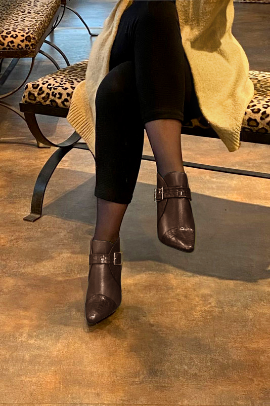 Dark brown women's ankle boots with buckles at the front. Tapered toe. Very high kitten heels. Worn view - Florence KOOIJMAN